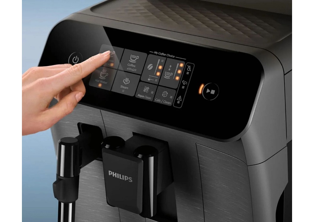 Detail: Hand tapping the touch control panel of the Philips coffee machine to select a beverage.