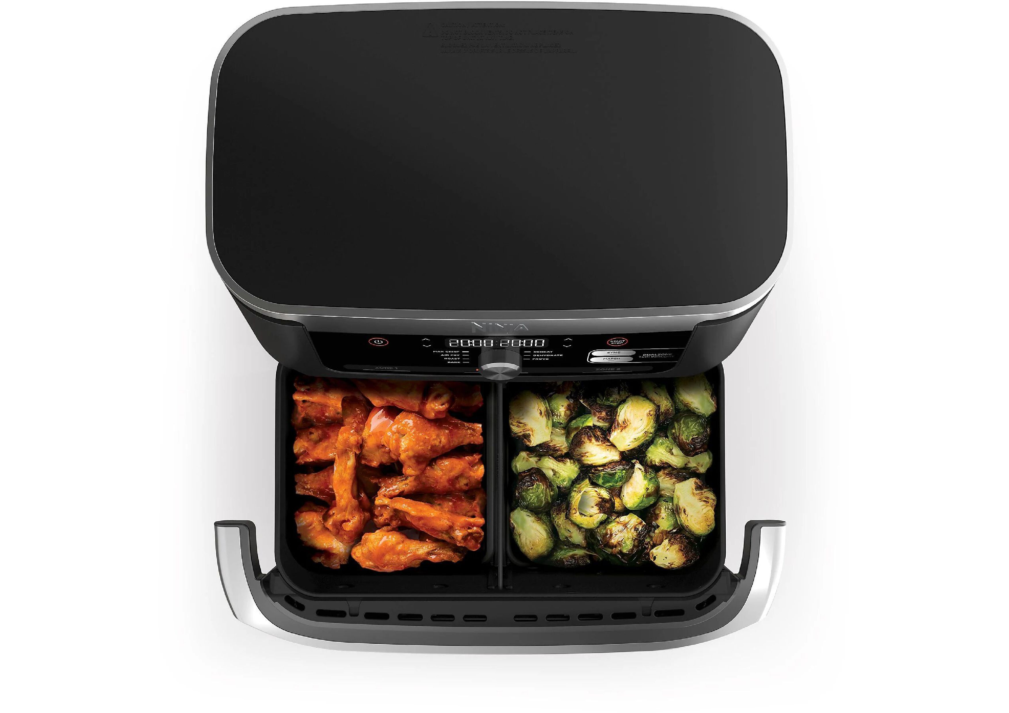 Top-down view into filled cooking zones: Chicken wings on the left, Brussels sprouts on the right