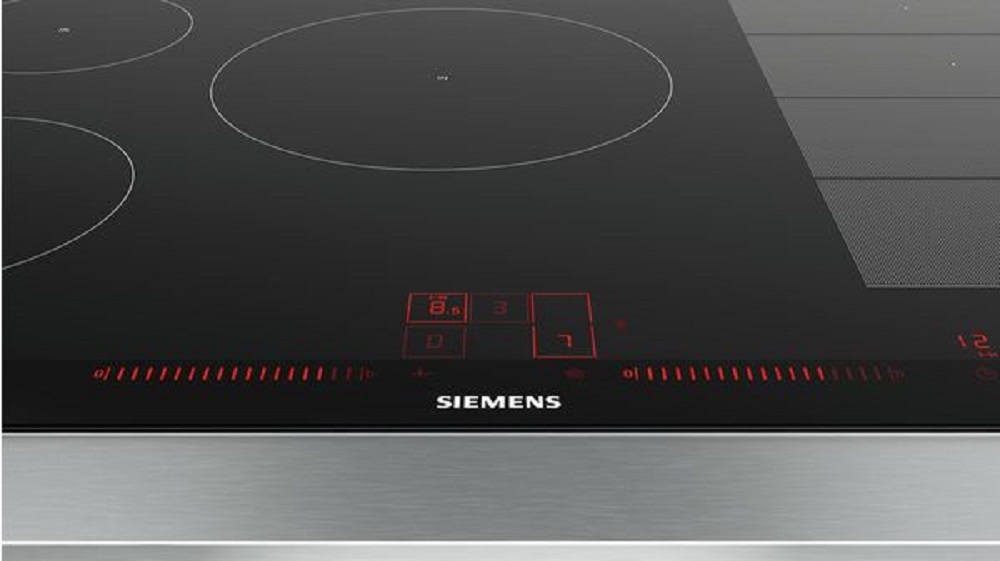 Close-up of the Siemens EX875LVC1E induction hob's touch control panel with red digital displays and slider control.