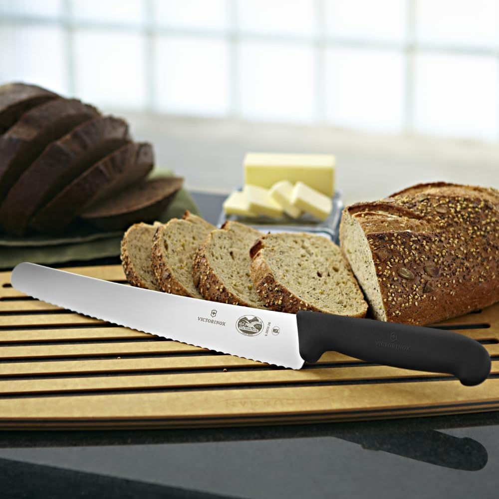 The Victorinox pastry knife slicing a layer of cake or pastry.