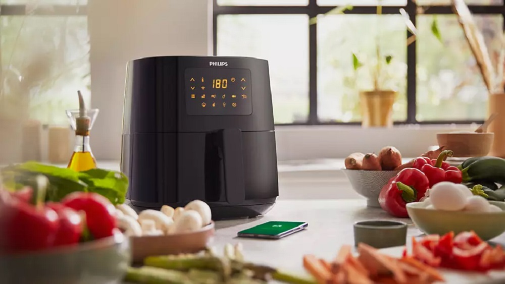 Philips HD9255/90 Airfryer on countertop with fresh ingredients