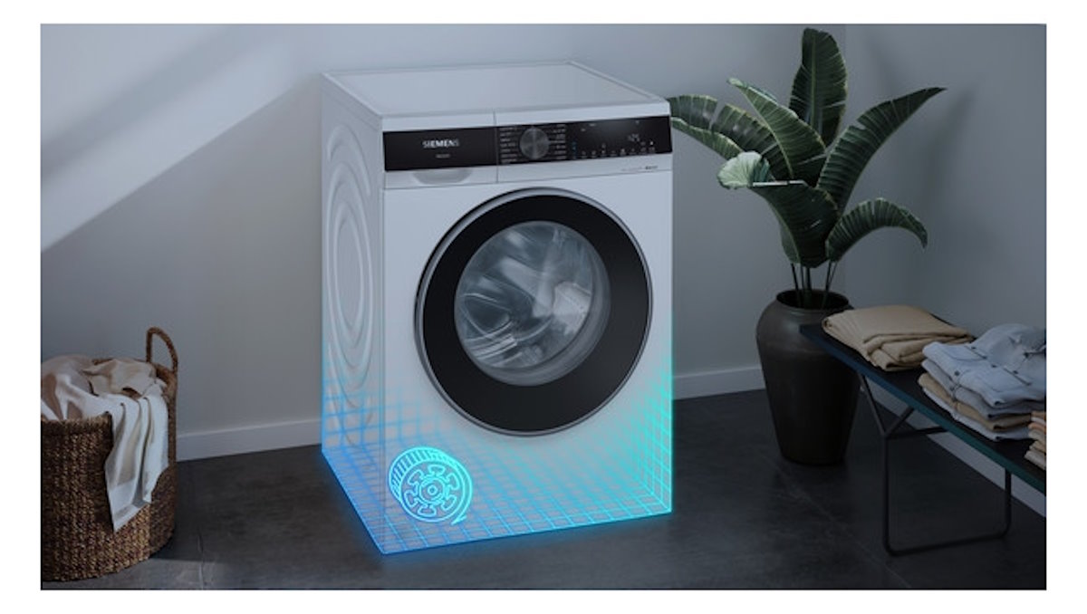 Siemens WM14N0G4 washing machine in a modern bathroom, built into a wall niche.