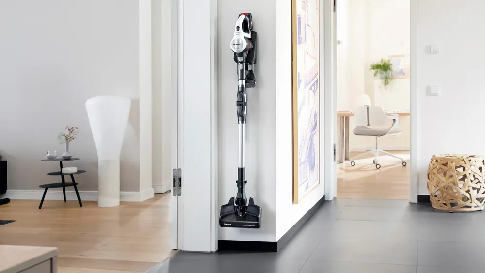 BOSCH BSS711W cordless vacuum stored space-savingly on the wall mount.