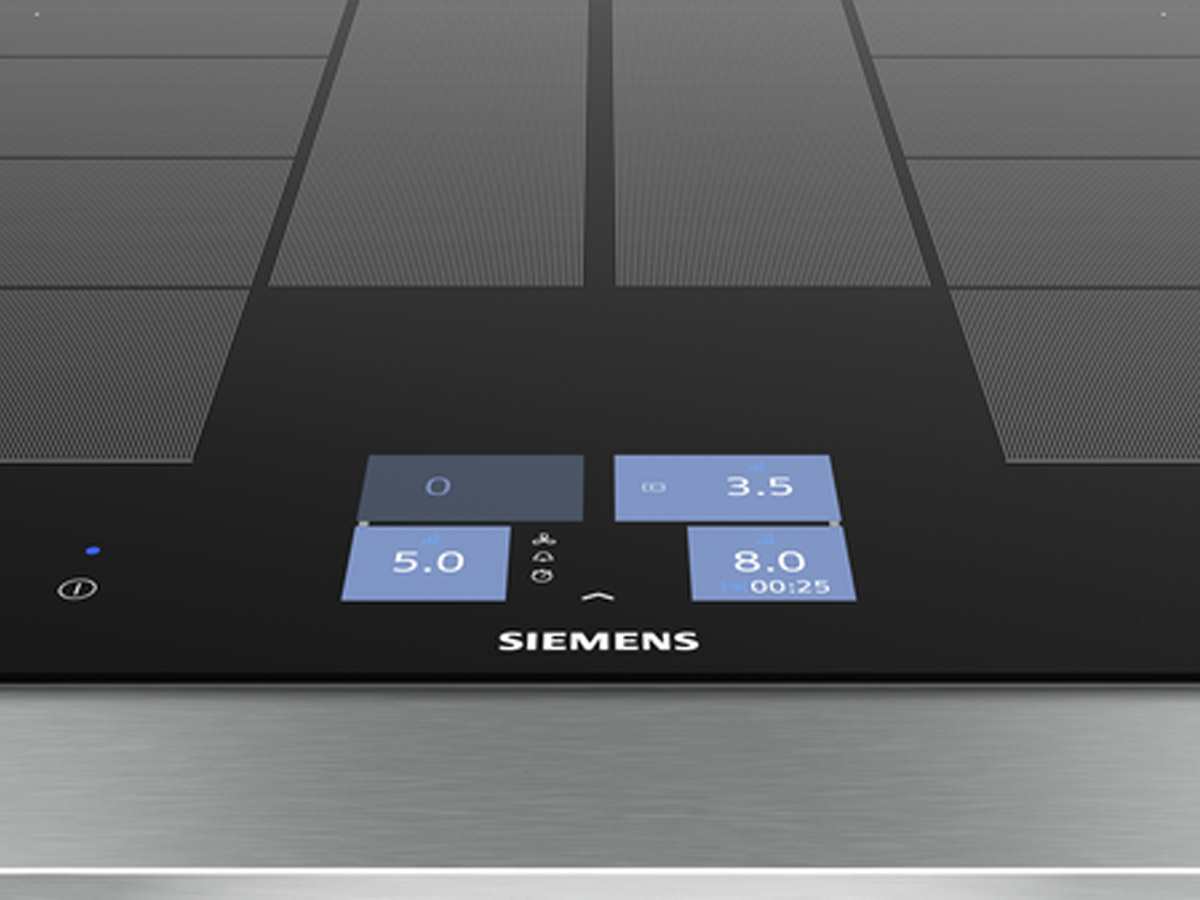Close-up of the Siemens induction hob's control panel with vibrant blue touch controls and digital display for power levels and timer.