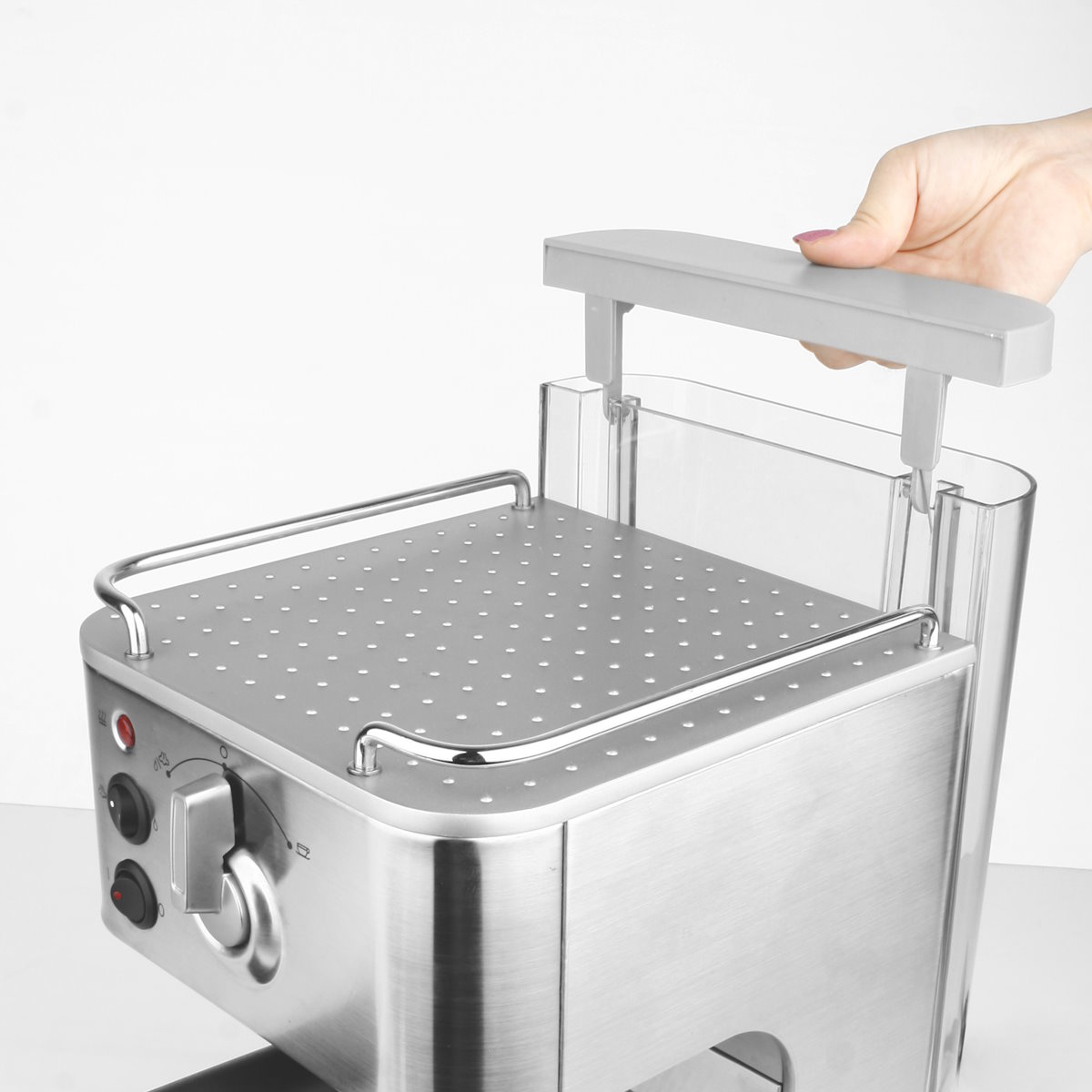 A hand removing the clear water tank from the back of the Gastroback Design Espresso Plus espresso machine.