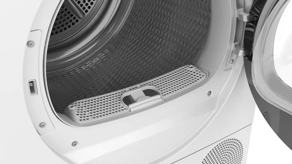 Close-up of the lower lint filter (sieve) inside the open porthole of the dryer, ready to be removed for cleaning.