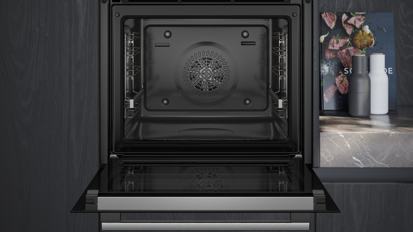 Close-up of the oven's interior with the door open, showing the pyrolytic-ready cavity and the hot air fan.