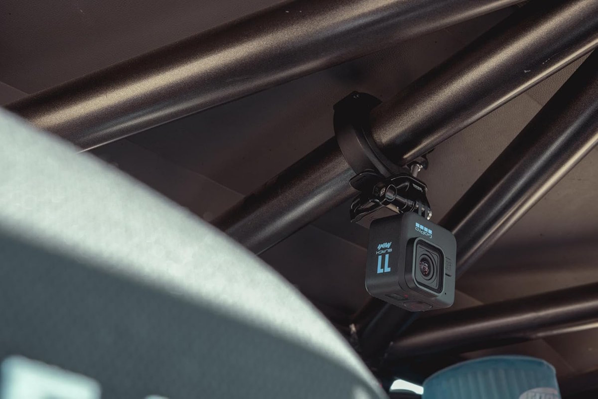 GoPro HERO11 Black Mini with mounting buckle and adhesive mount.