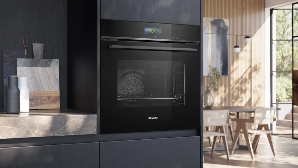 SIEMENS HB776G1B1 iQ700 built-in oven in a modern, dark kitchen unit, door closed