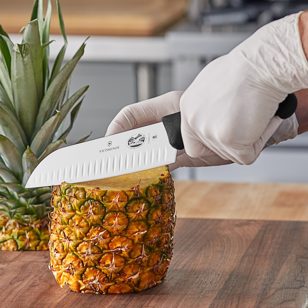 Victorinox Santoku knife in the kitchen, cutting a pineapple