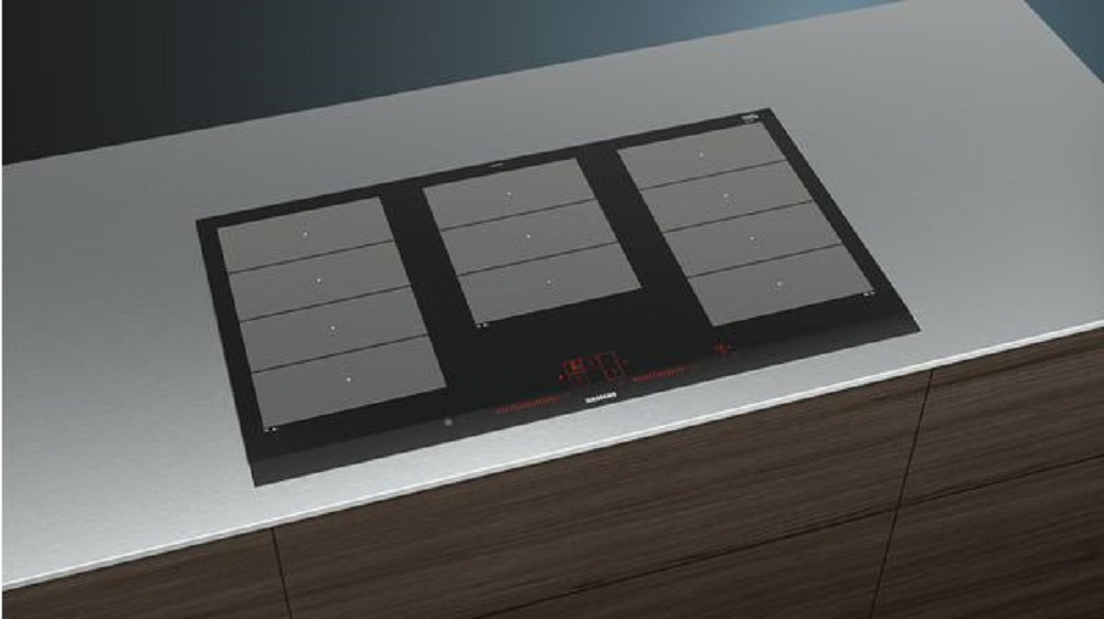 Siemens EX975LXC1E induction hob elegantly integrated into a modern kitchen countertop, with active control panel.