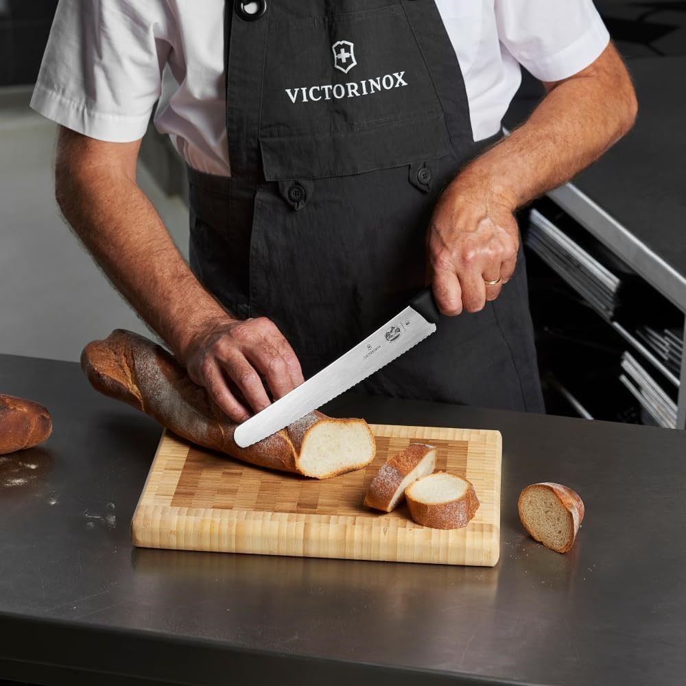 The Victorinox bread knife slicing a piece of fresh bread.