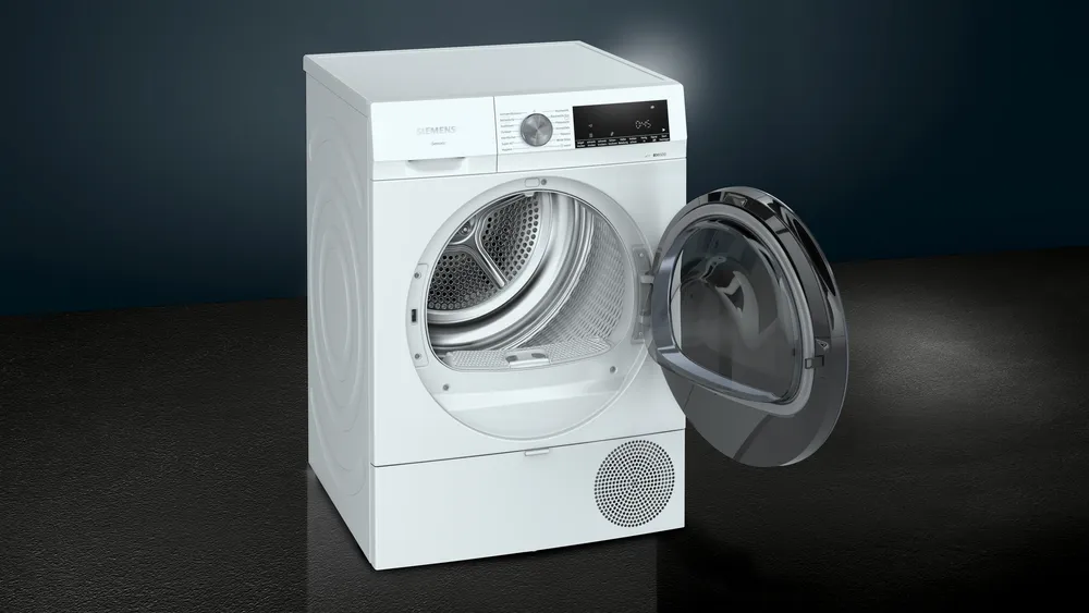 he Siemens heat pump tumble dryer with the porthole door open and a glossy black trim, revealing the drum inside.