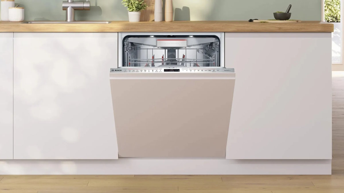 Side view of the Bosch SMV8YCX02E with the door fully open, showing the interior layout and the basket system.