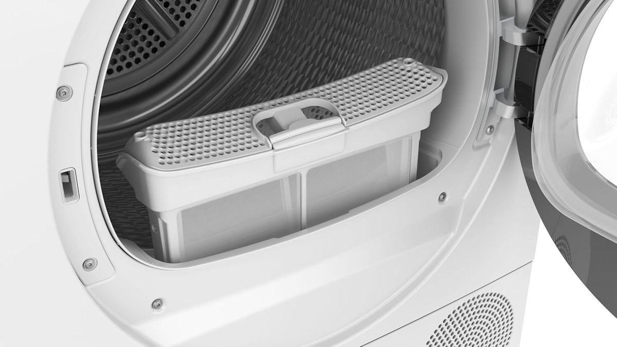 Interior view of the stainless steel drum of the Siemens WQ33G2D40 with the lint filter removed in front of the opening