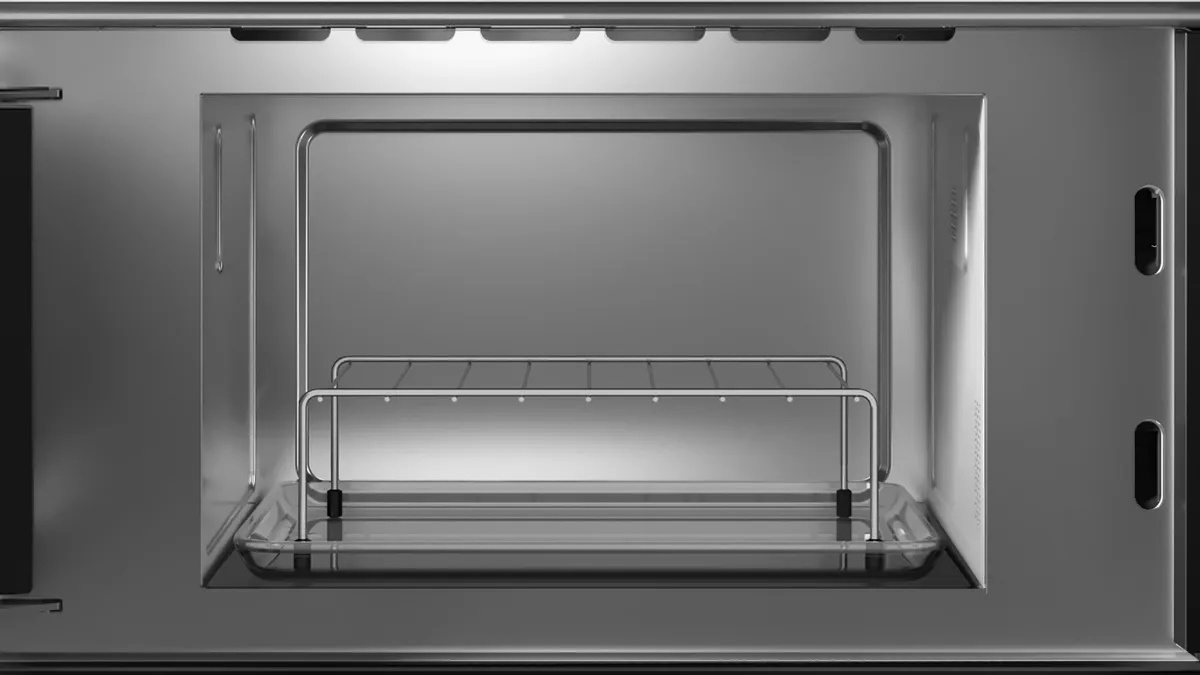 Interior view of the Siemens microwave cavity with glass dish and grill rack inserted.